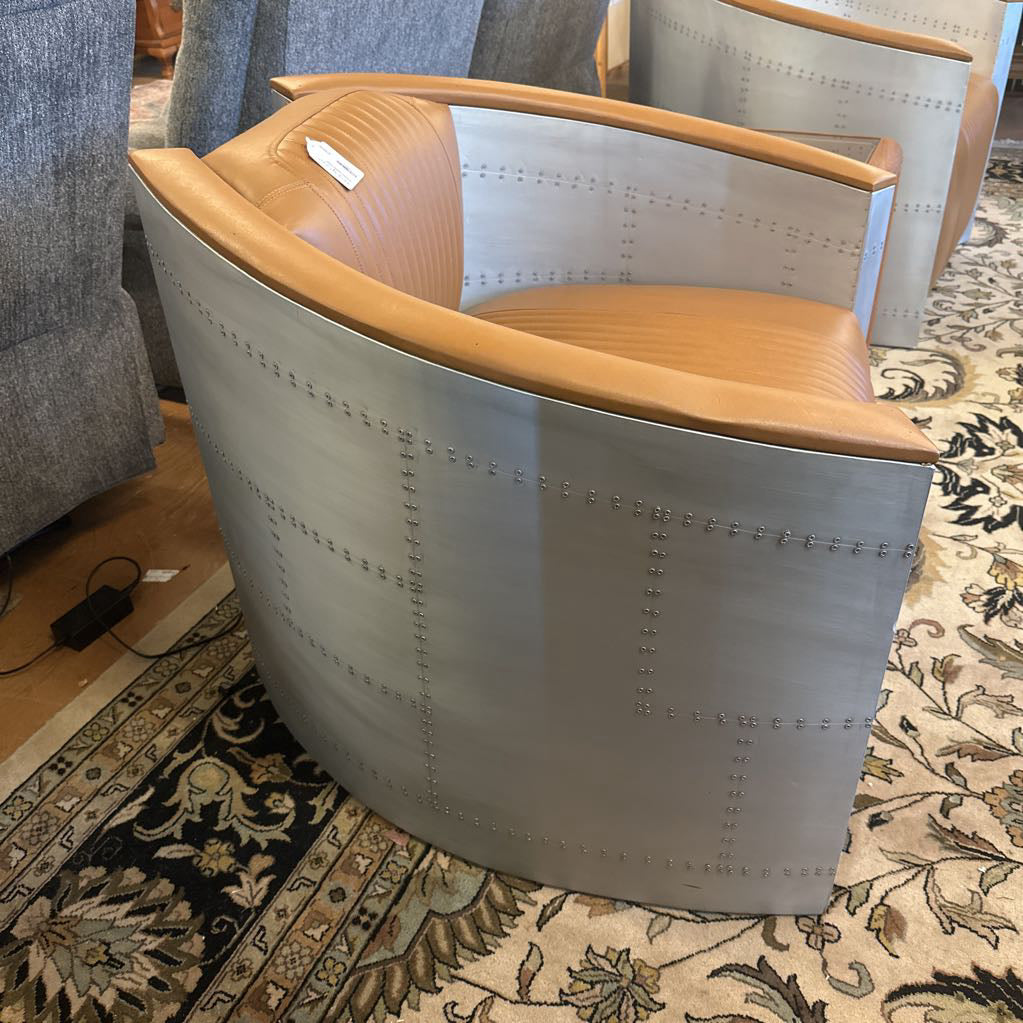 Modern chair with wooden seat and metallic frame on a patterned rug