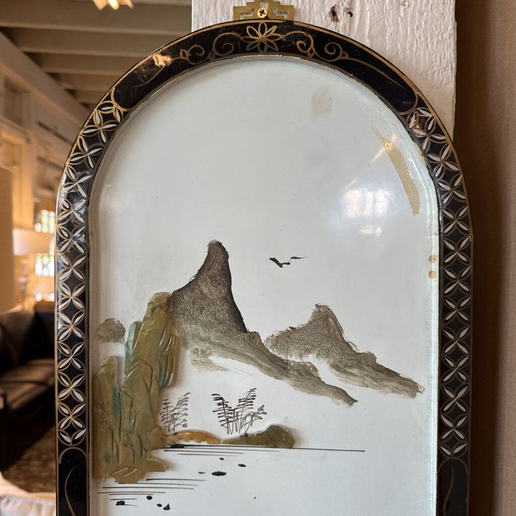 Decorative wall piece with mountain and bird design in a decorative frame.