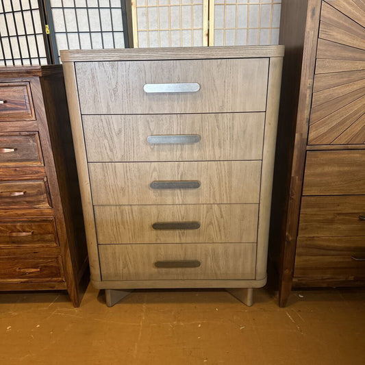 Wooden dresser with four drawers in a room setting