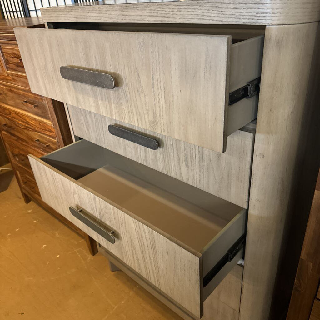 Wooden dresser with open drawers on a wooden floor