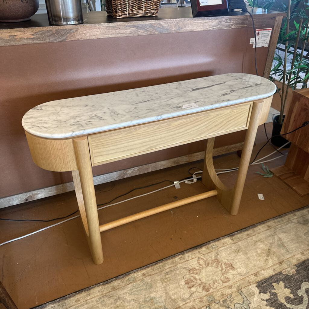 Wooden console table with marble-like top on a cardboard surface