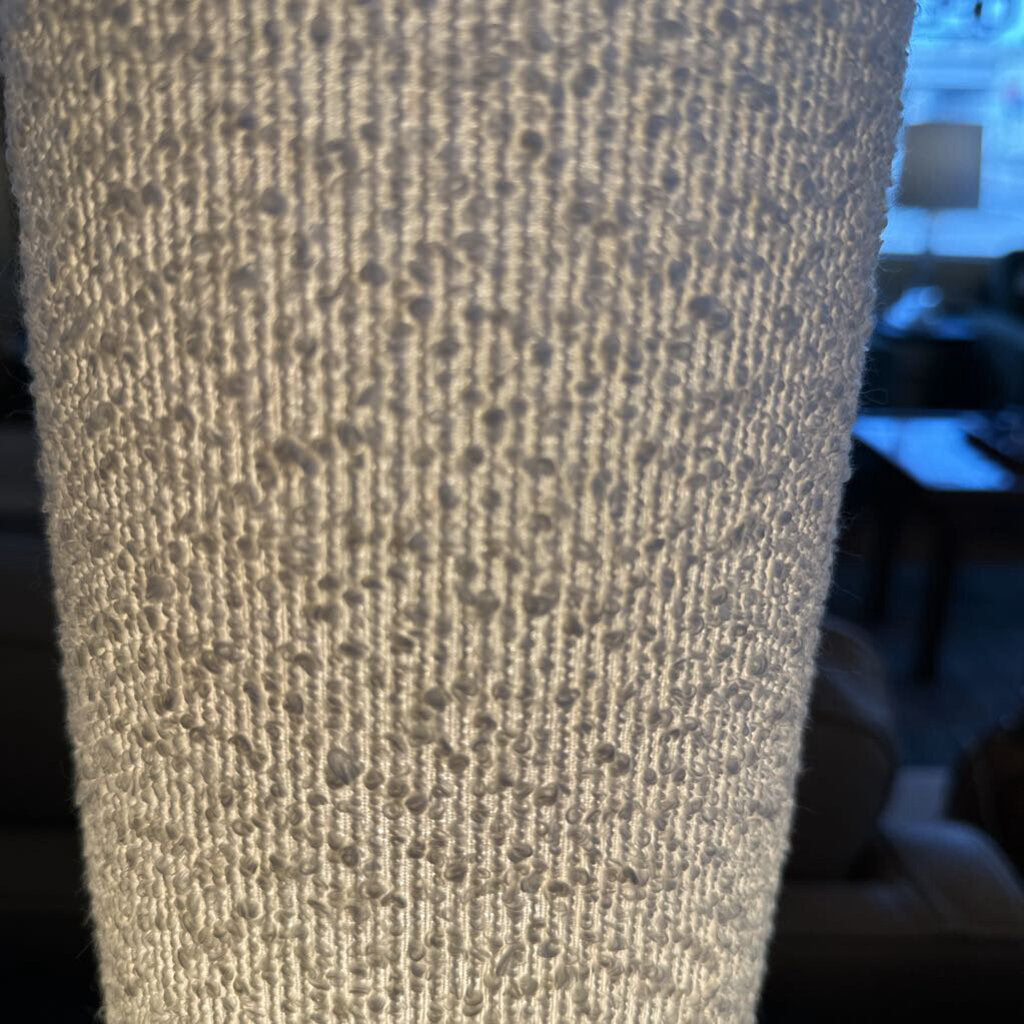 Close-up of textured beige fabric with a blurred background