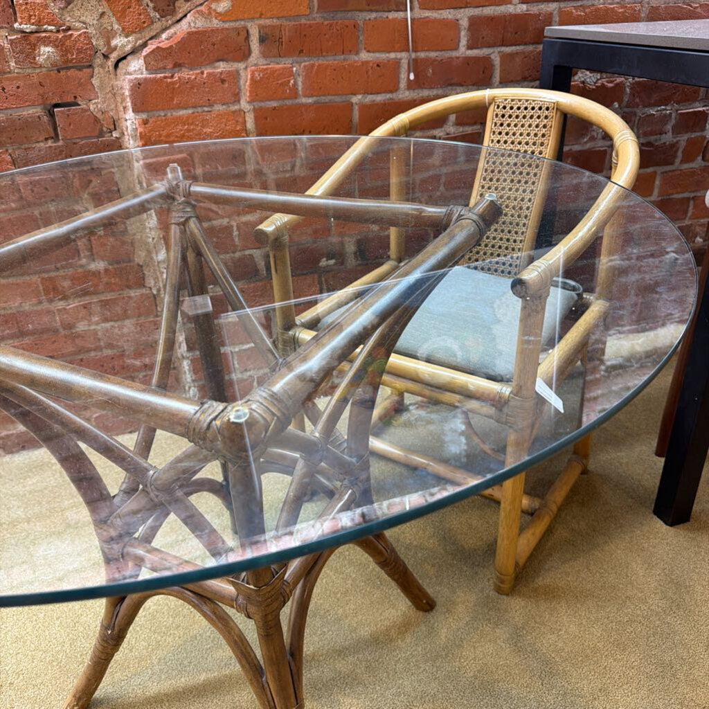 Rattan chair and table set against a brick wall.