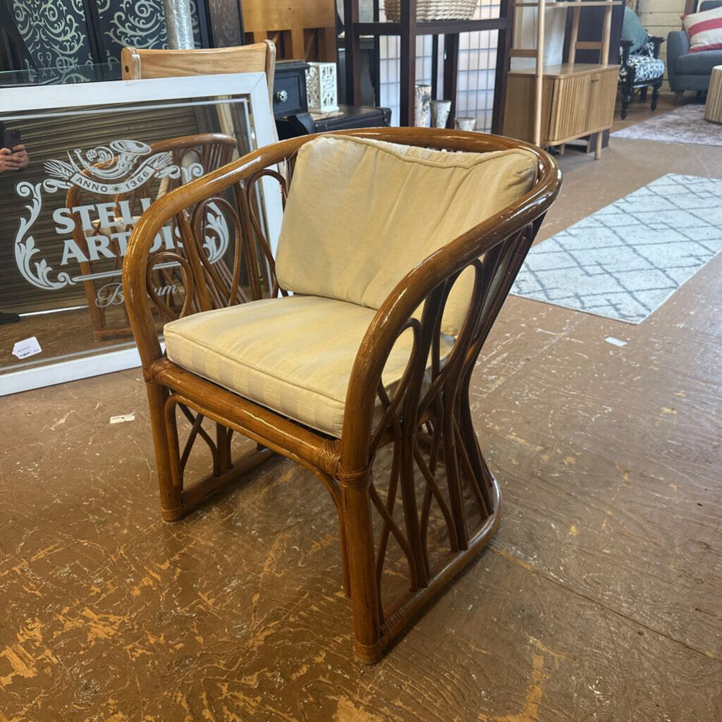 Wooden chair with beige cushion on a wooden floor