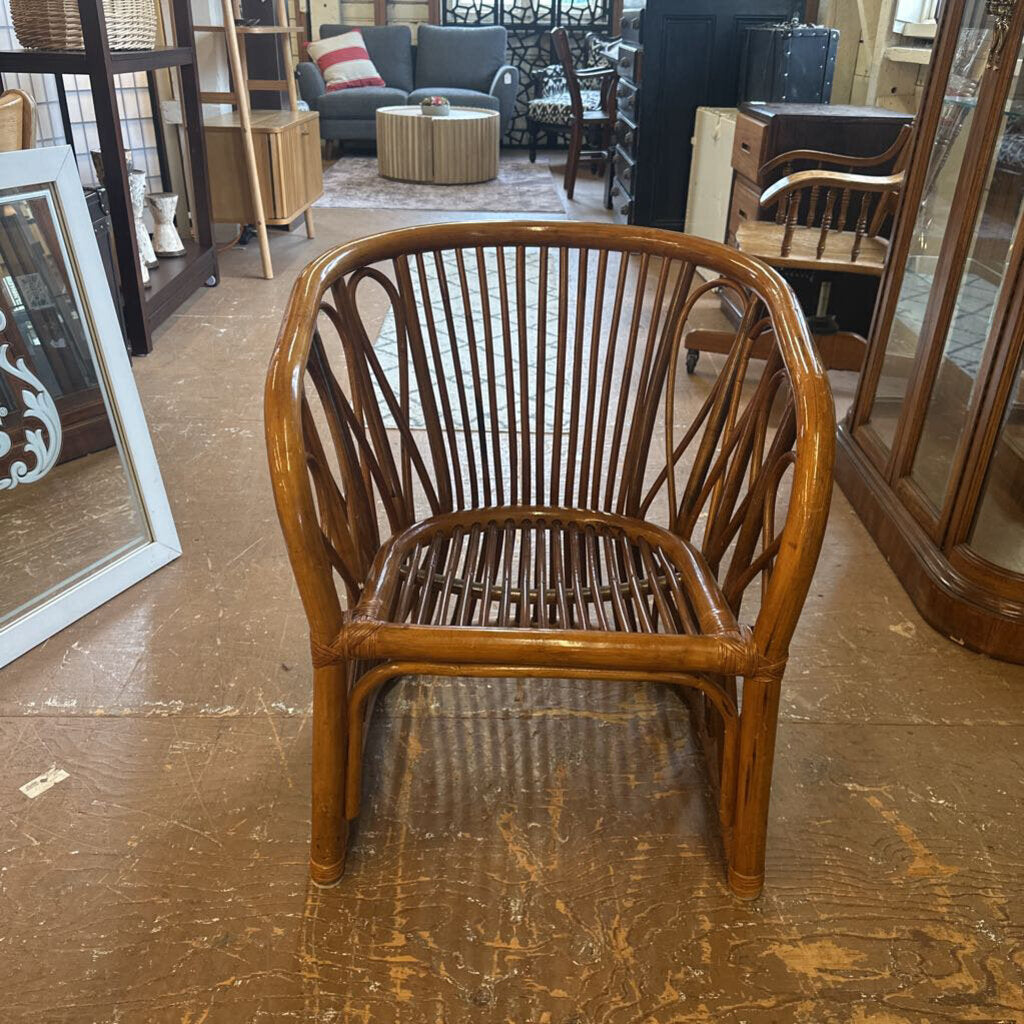 Wooden chair with wicker back and seat in a room with furniture and decor.