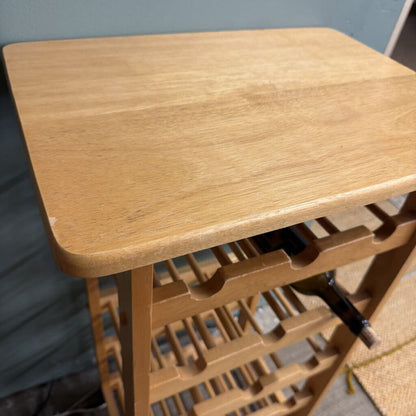 Wooden wine rack with a table on a neutral background