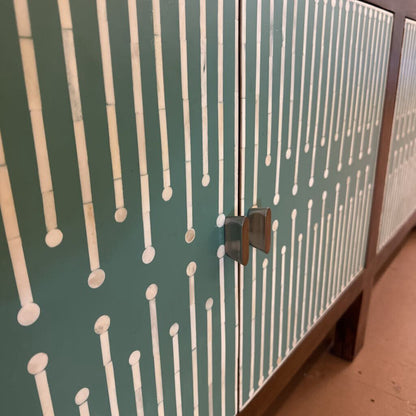 Cabinet with a bamboo pattern on a green background