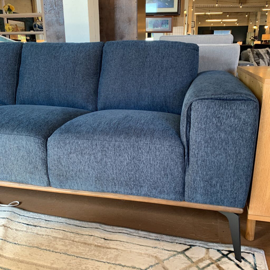 Blue sofa with wooden frame in a room setting