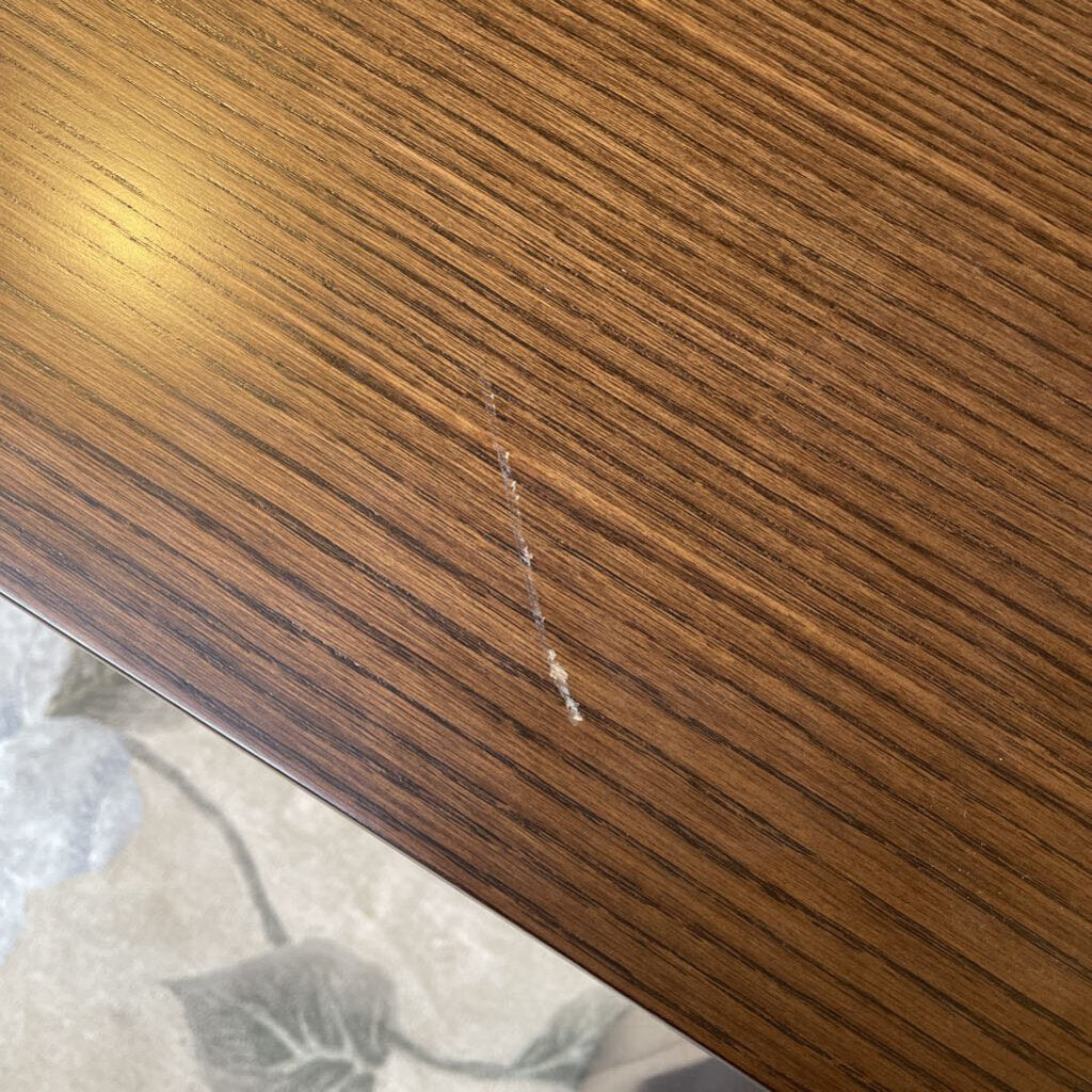 close up of damage, a scratch, on a walnut wood dining table