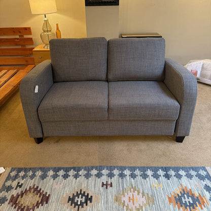 Gray sofa in a room with a patterned rug