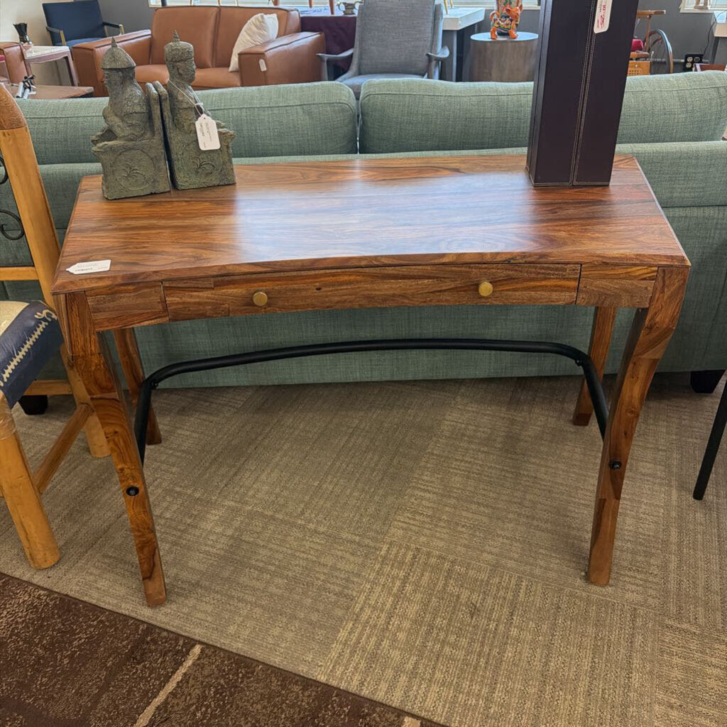 Wooden desk with a drawer in a furniture store setting