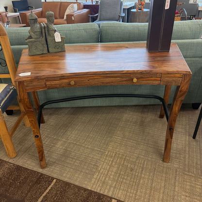 Wooden desk with a drawer in a furniture store setting