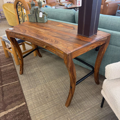 Wooden table in a room with furniture and decor items.