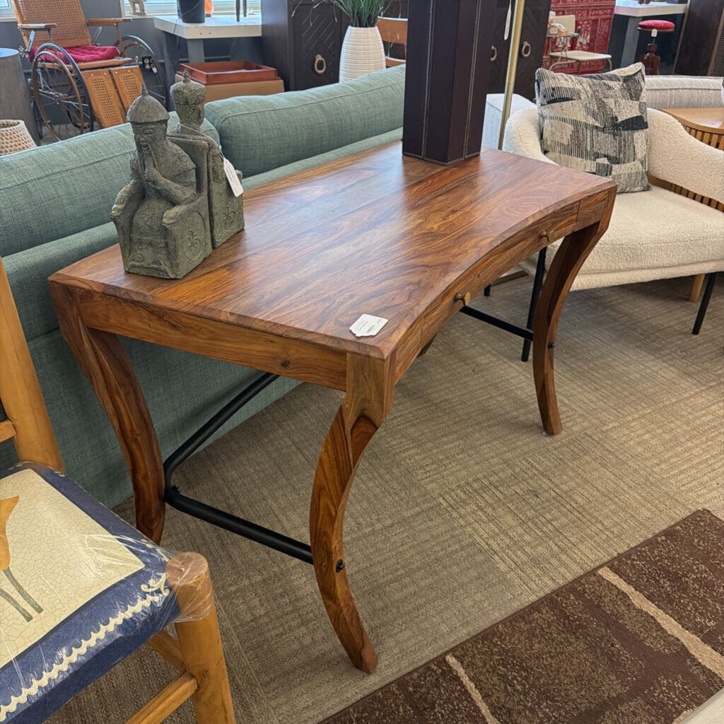 Wooden coffee table with decorative items in a room with furniture and decor.