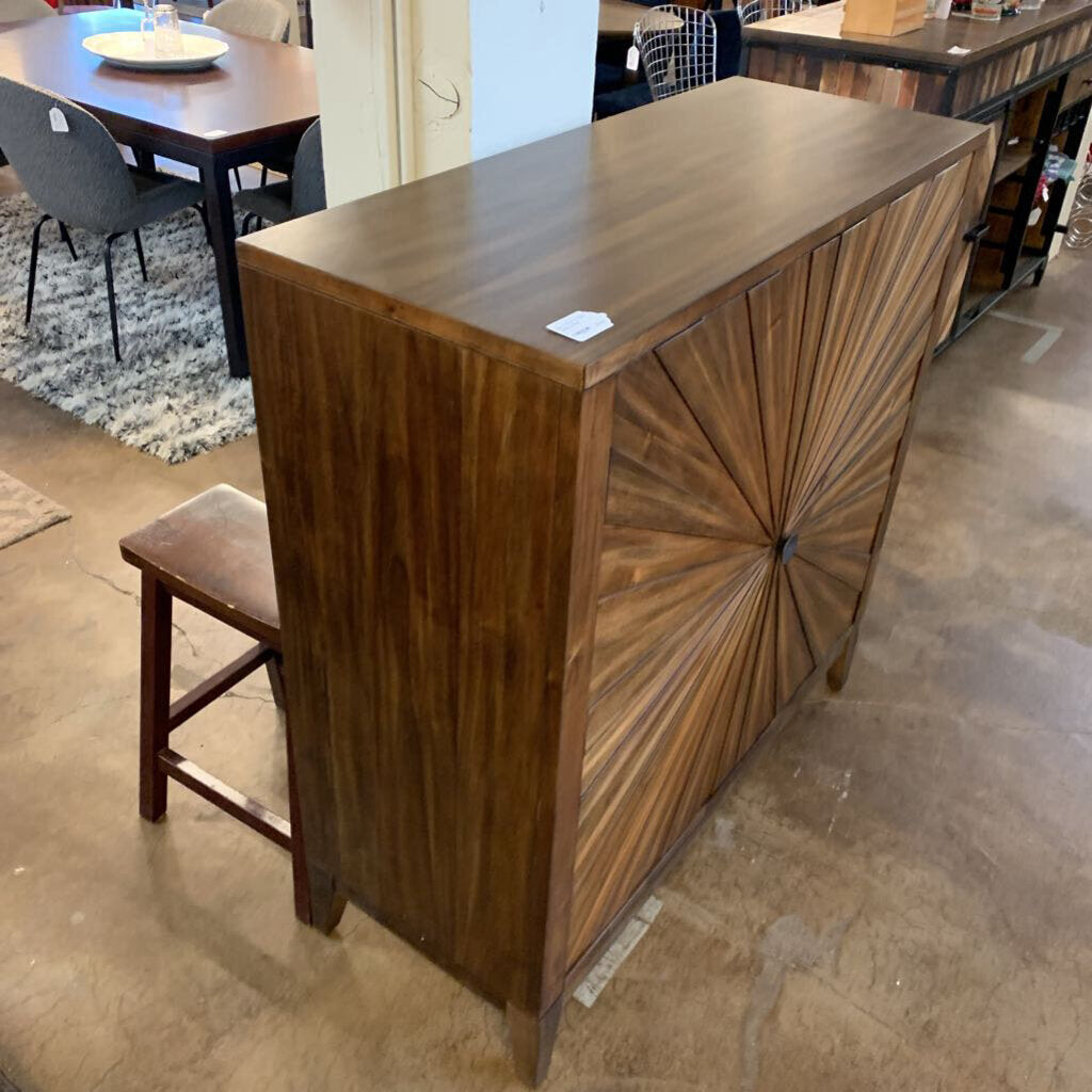 Wooden bar counter with decorative design in a showroom setting