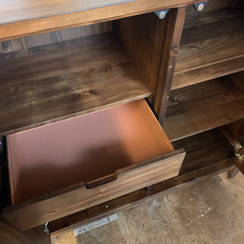 Wooden dresser with a drawer open, showing a worn surface.