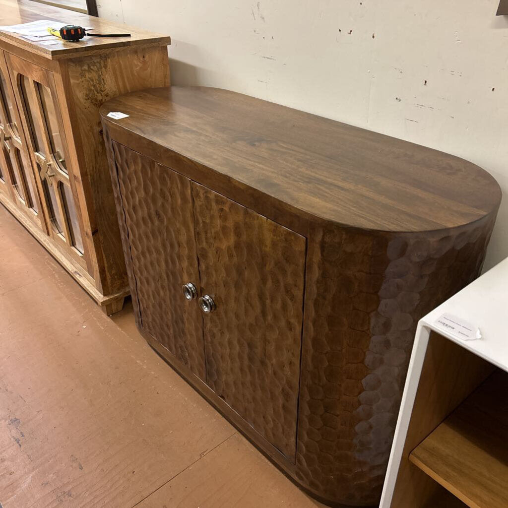 Wooden cabinet with hammered finish in a room setting