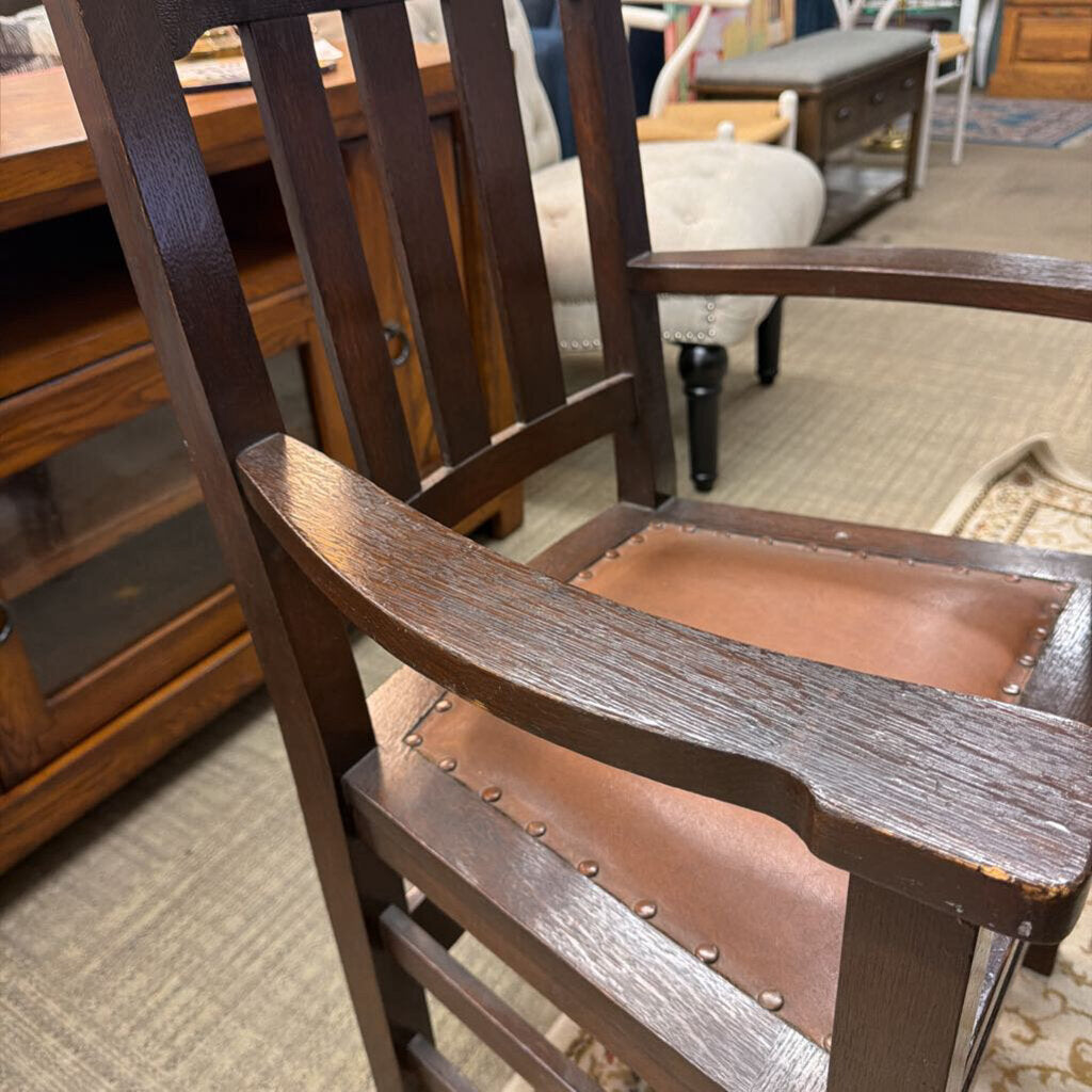 Wooden chair with brown cushioned seat in a room setting
