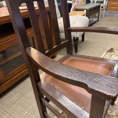 Wooden chair with brown cushioned seat in a room setting