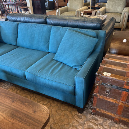 Blue sofa in a room with wooden floors and furniture