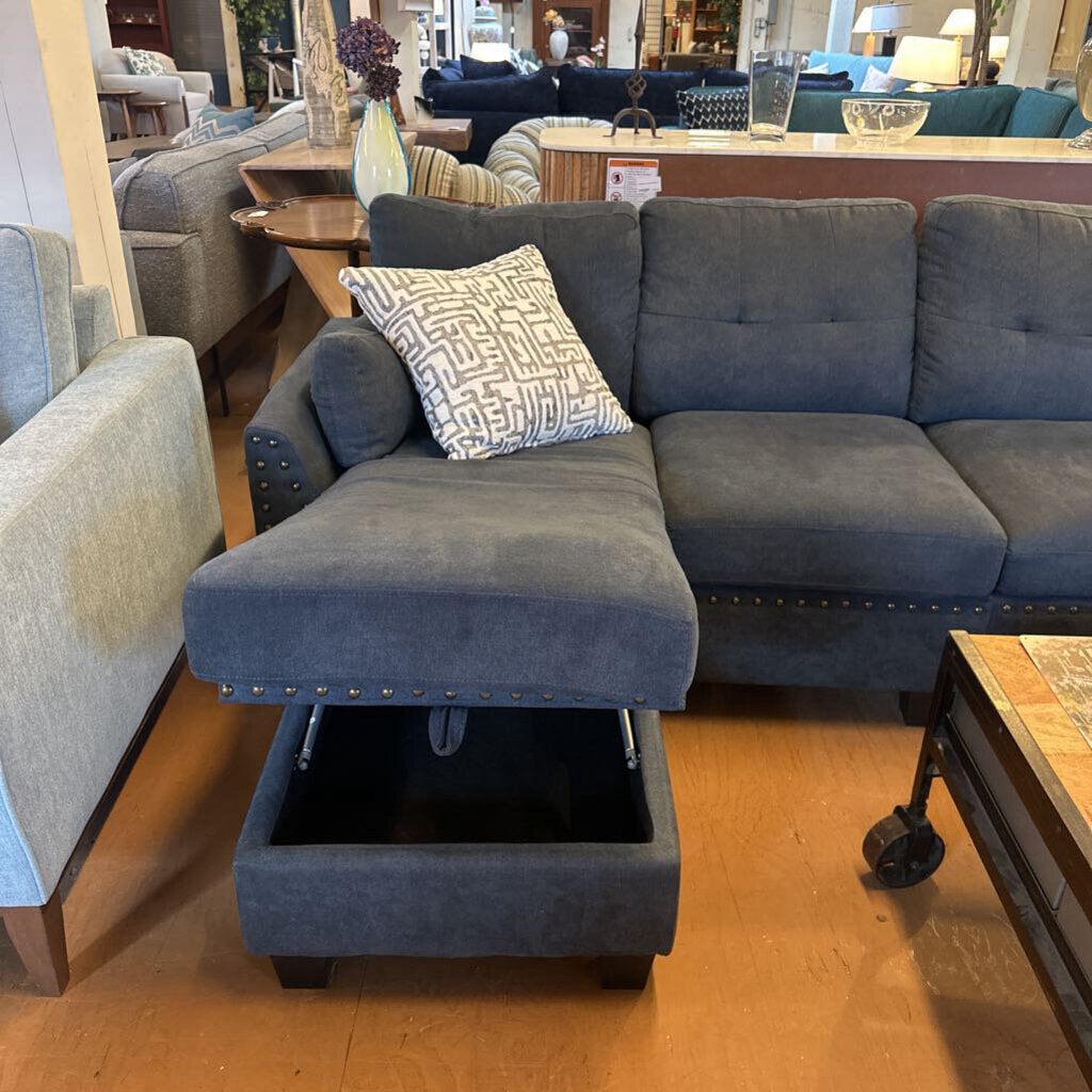 Gray sectional sofa with storage ottoman in a furniture store
