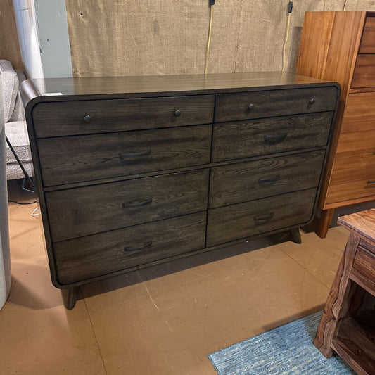 Wooden dresser with multiple drawers in a room setting
