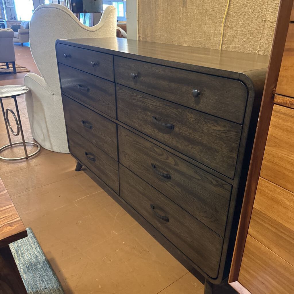 Wooden dresser with multiple drawers in a room setting