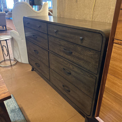 Wooden dresser with multiple drawers in a room setting