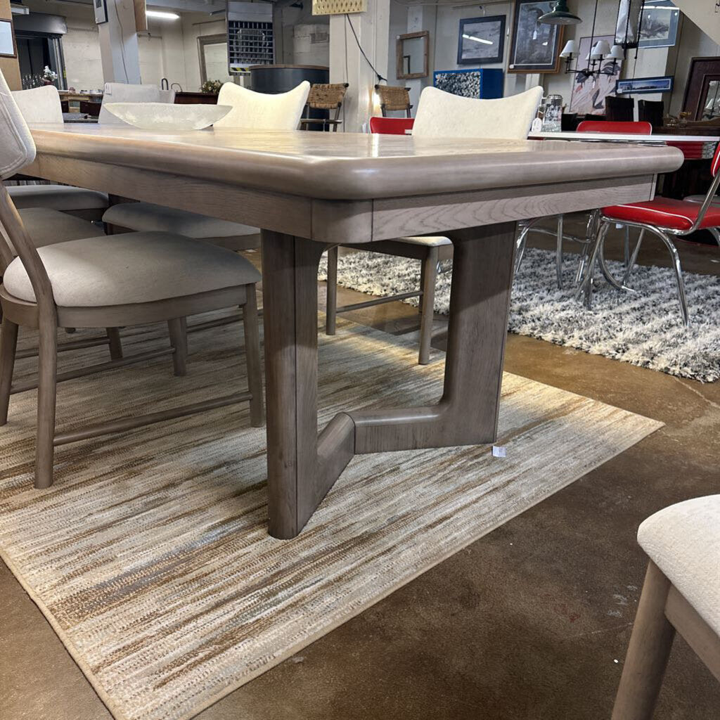 Dining table with chairs in a showroom setting