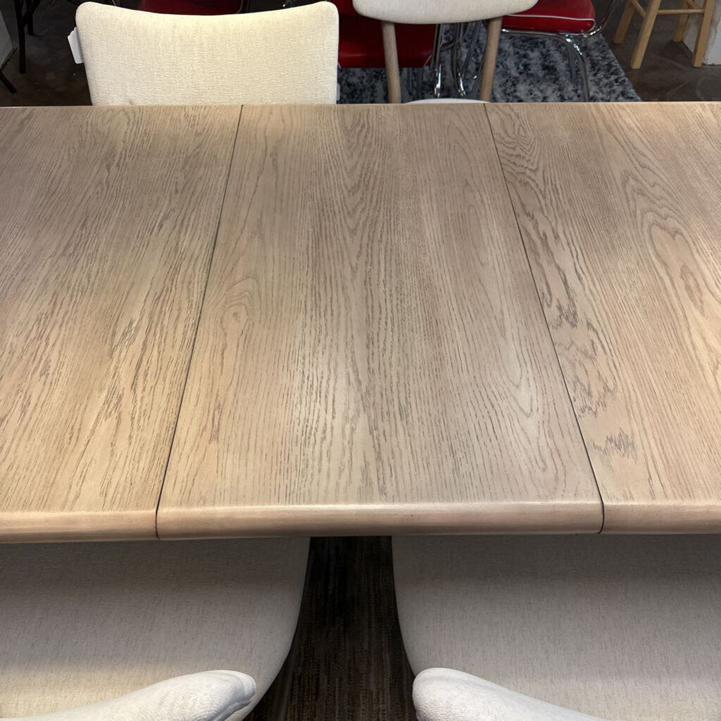 Wooden dining table with chairs in a room setting
