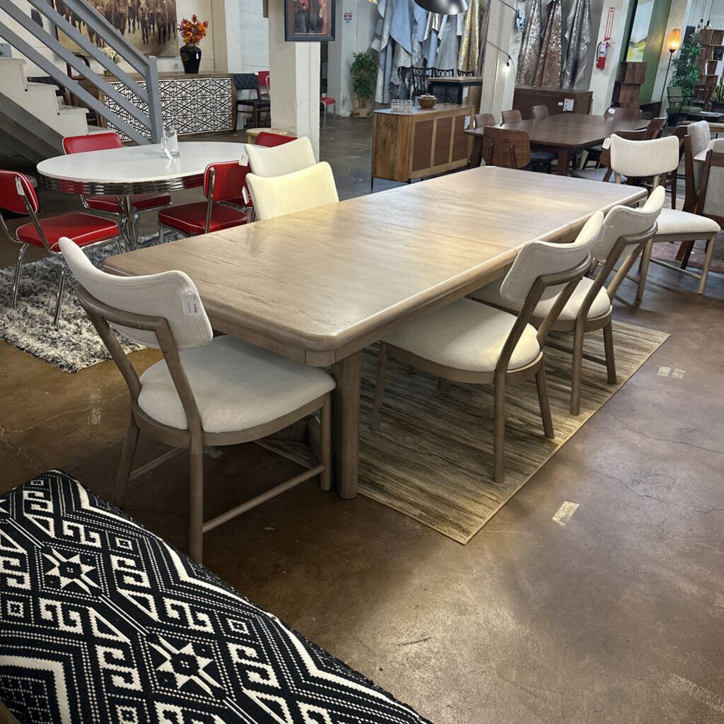 Dining area with wooden table and chairs in a showroom setting