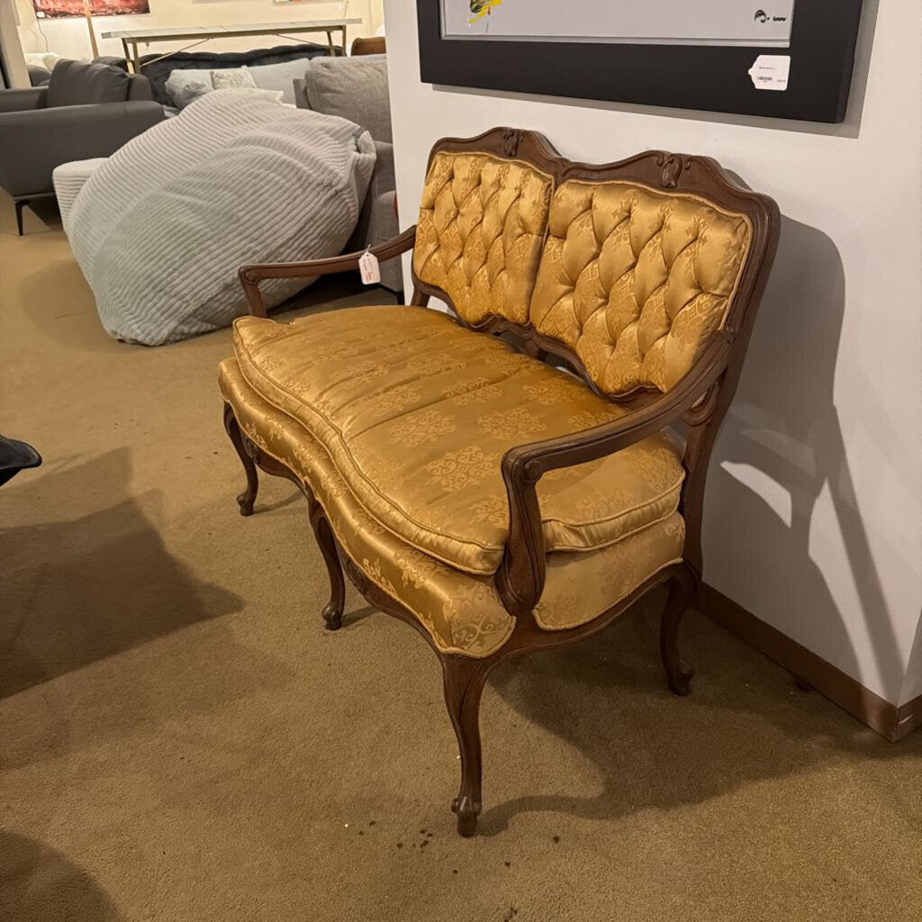Vintage-style yellow bench with wooden frame in a room setting