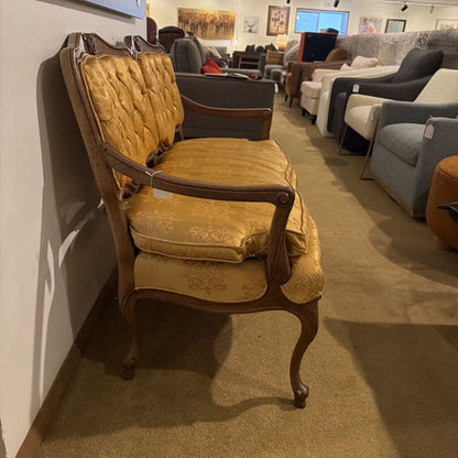 Vintage yellow chair with wooden frame in a furniture store setting
