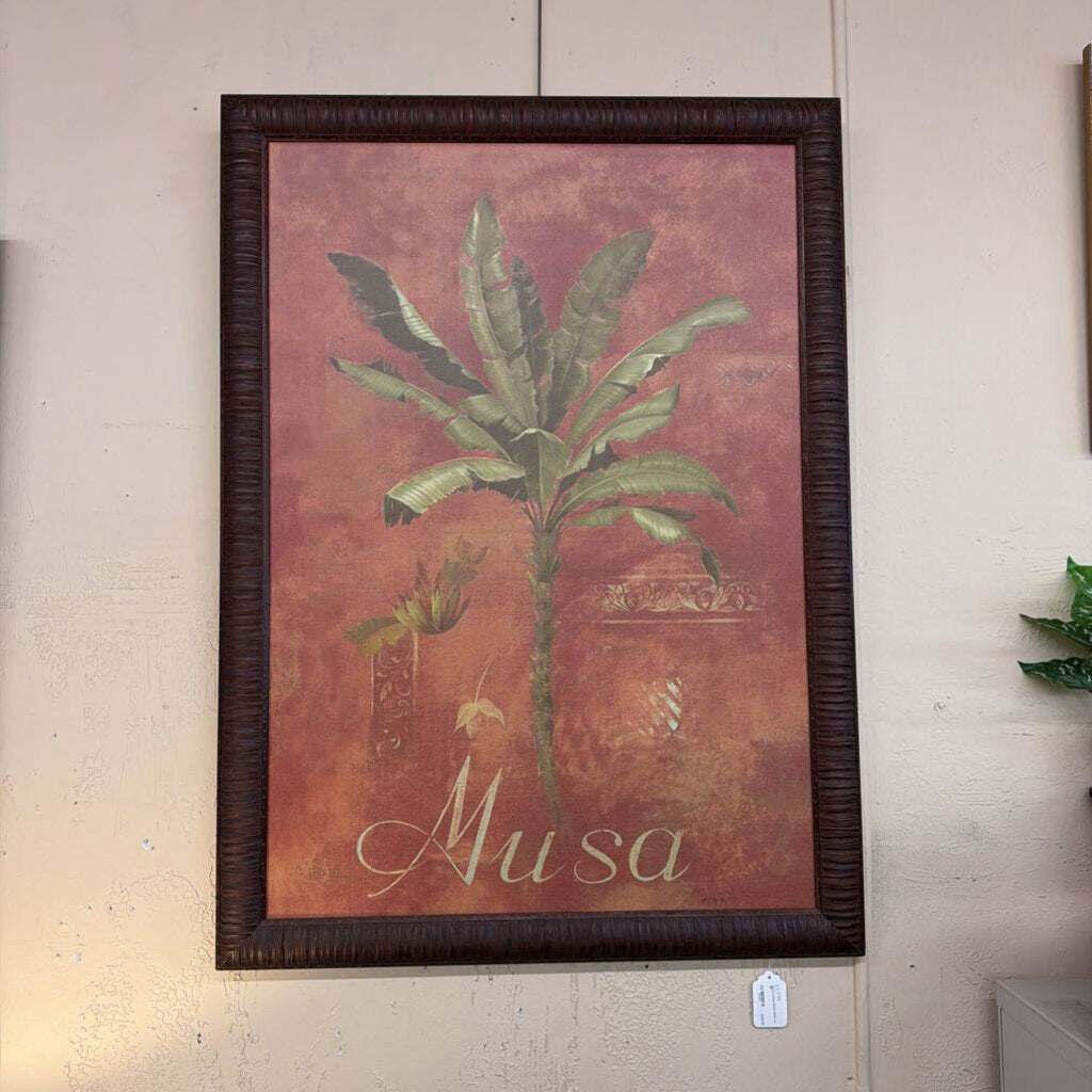 Framed artwork of a palm tree with 'Musa' text on a textured wall.