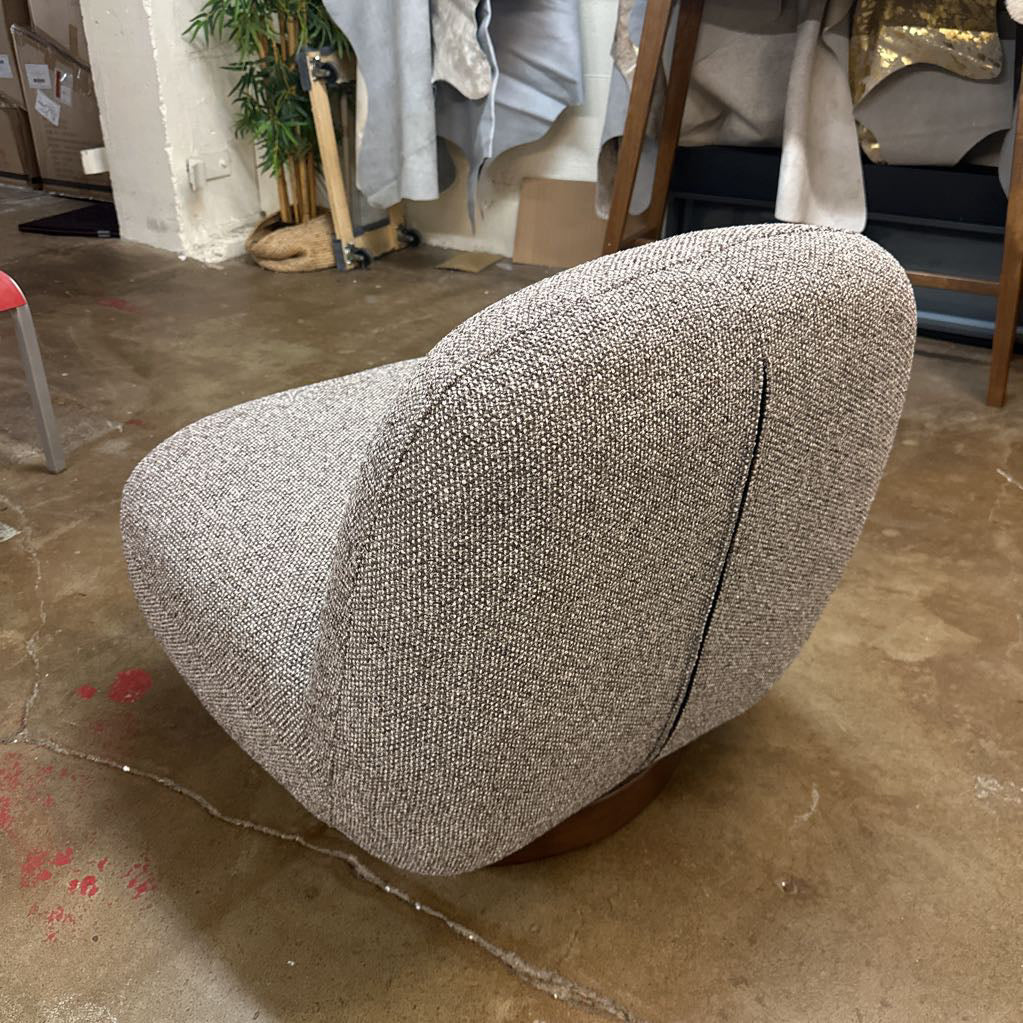 Textured gray car seat cover on a concrete floor with a cluttered background