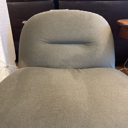 Gray cushioned chair with a blurred background