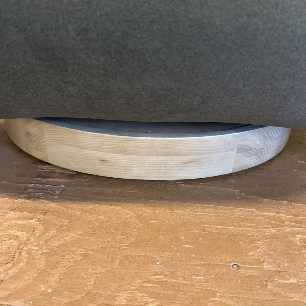 Close-up of a circular object with a textured surface on a wooden floor.