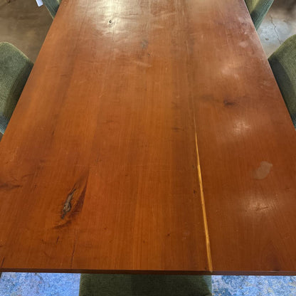 Wooden table with visible wear and tear in a room setting