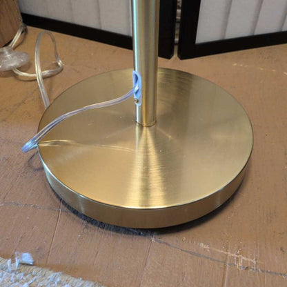 Gold metal base on a cardboard surface