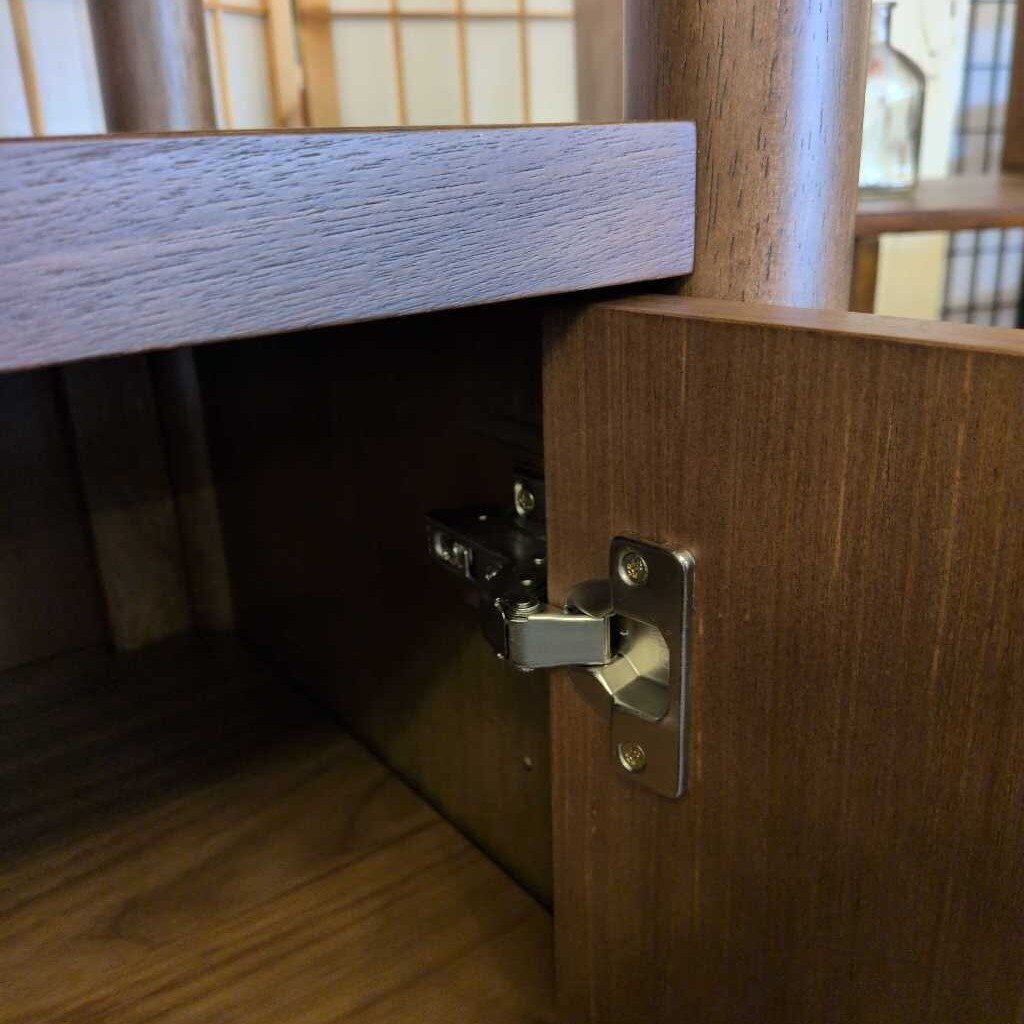 Wooden cabinet with a hinge on a wooden floor