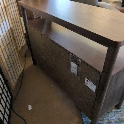 Wooden desk with a box underneath in an indoor setting