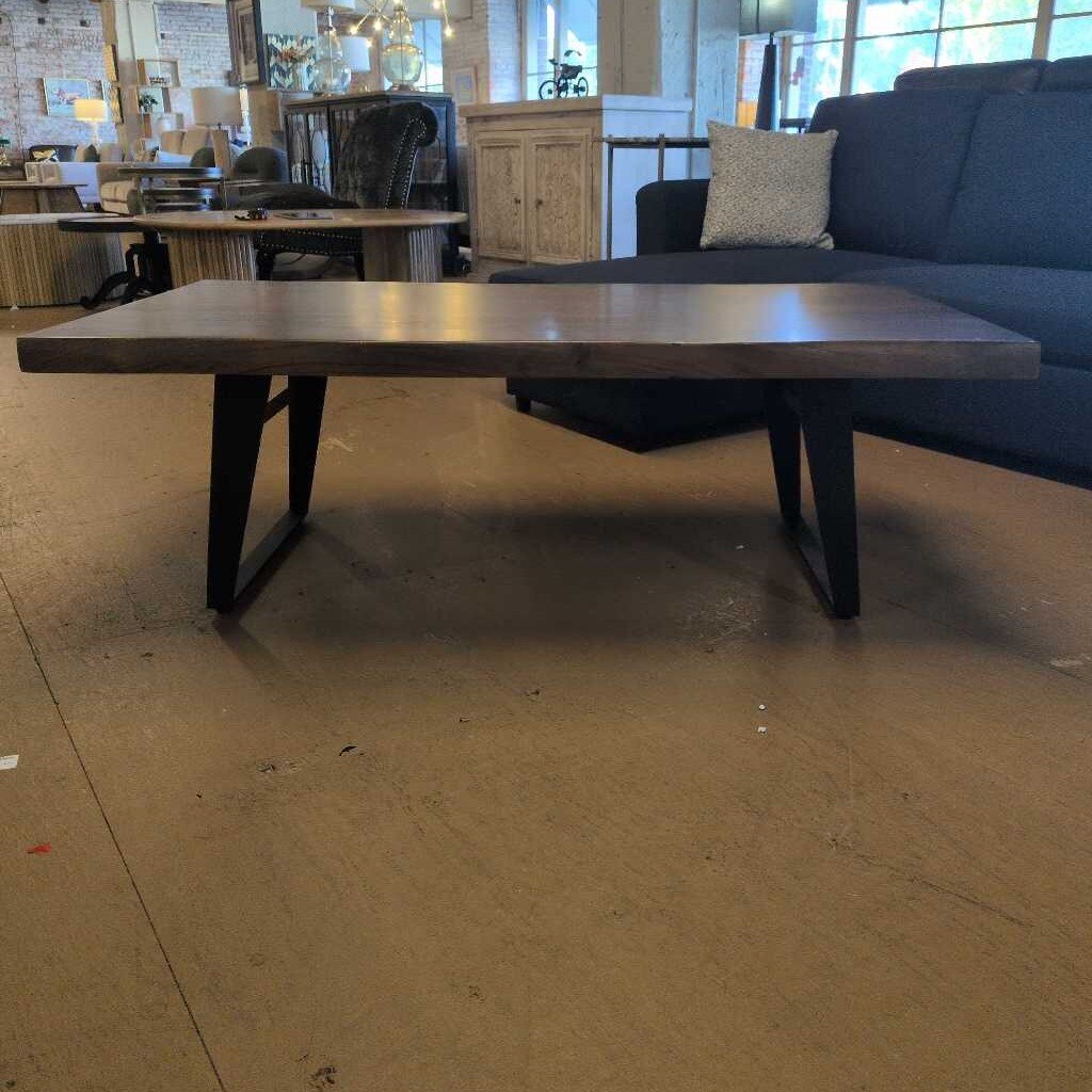 Long wooden table in a room with a couch and chairs.