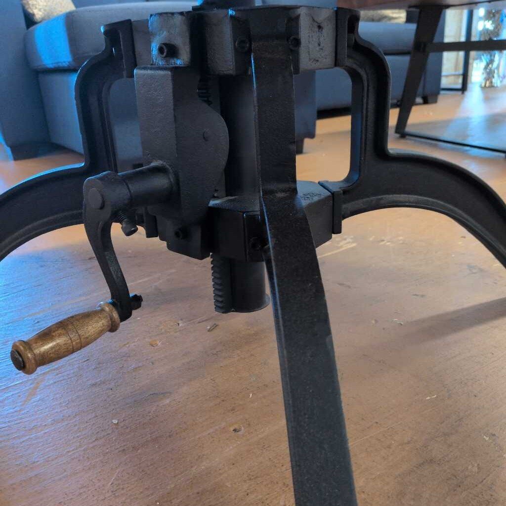 Black metal clamp on a wooden surface