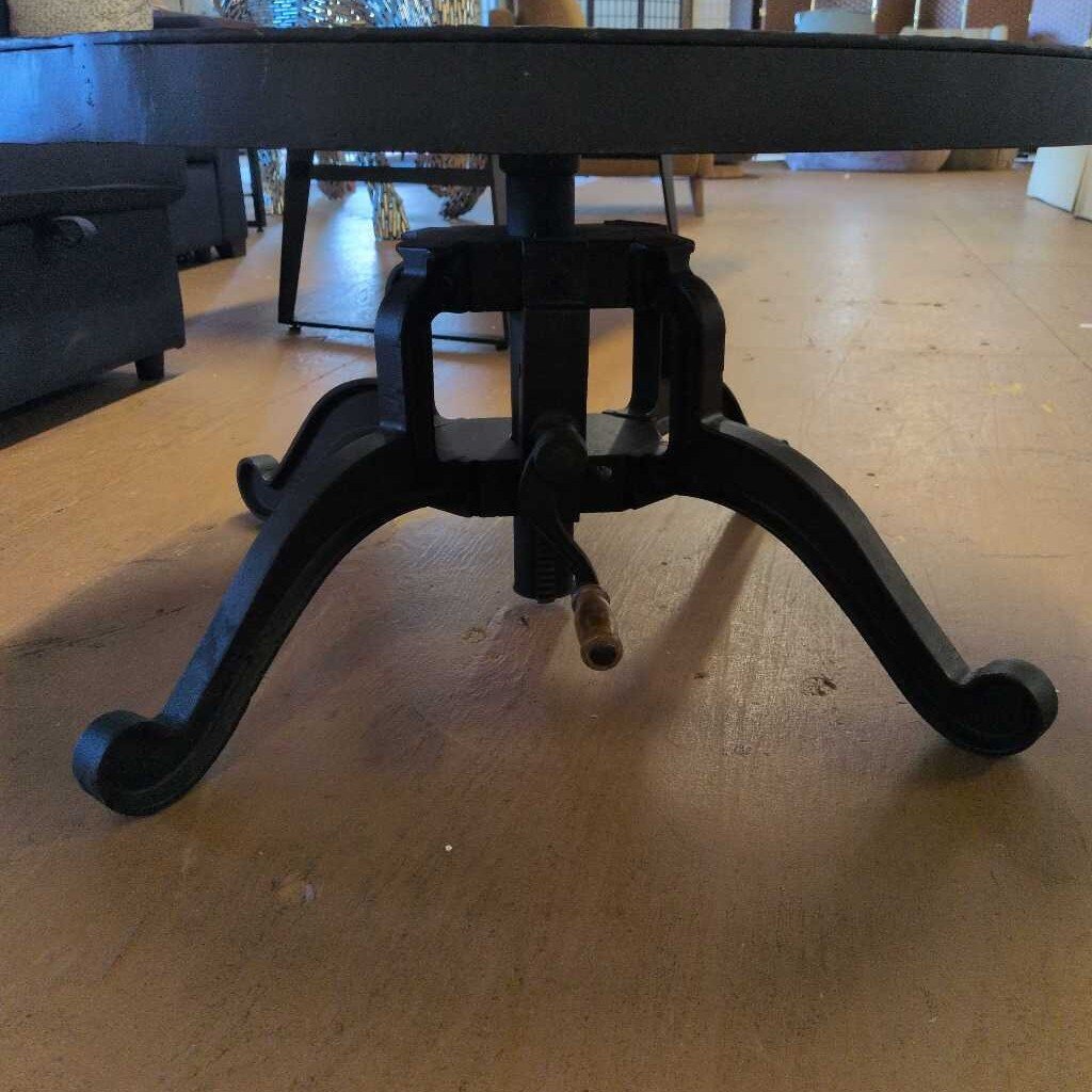 Black metal table base on a wooden floor