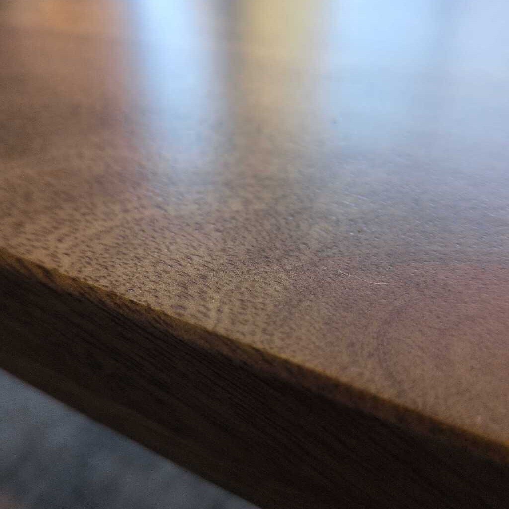 Close-up of a wooden surface with a blurred background