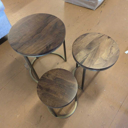 Three wooden stools on a wooden floor
