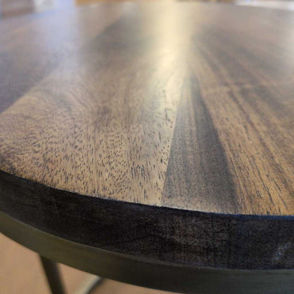 Close-up of a wooden table surface with visible grain and texture.