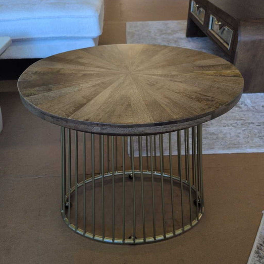 Round wooden coffee table with metal base in a living room setting