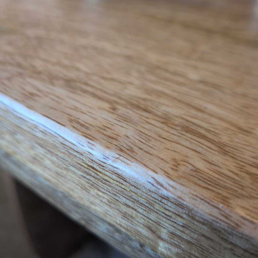 Close-up of a wooden surface with visible grain and texture.