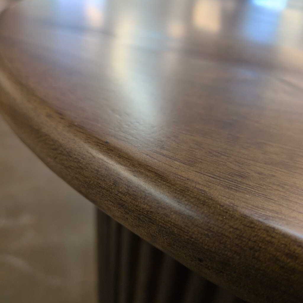 Close-up of a wooden table surface with a blurred background